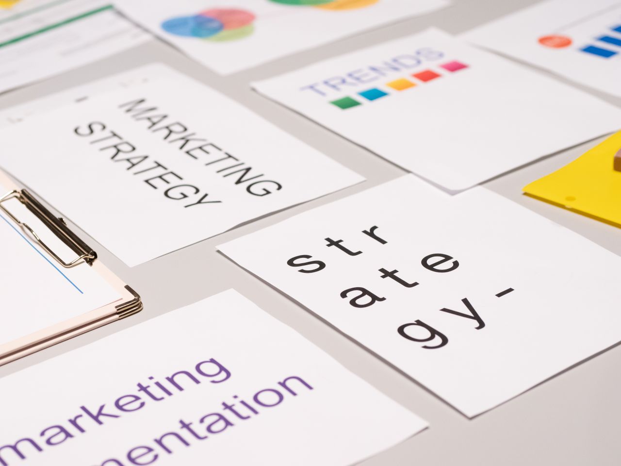 our-story A top view of marketing strategy documents and graphs arranged on a desk, showcasing business planning.